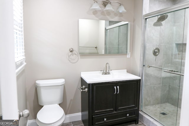 bathroom featuring walk in shower, vanity, and toilet