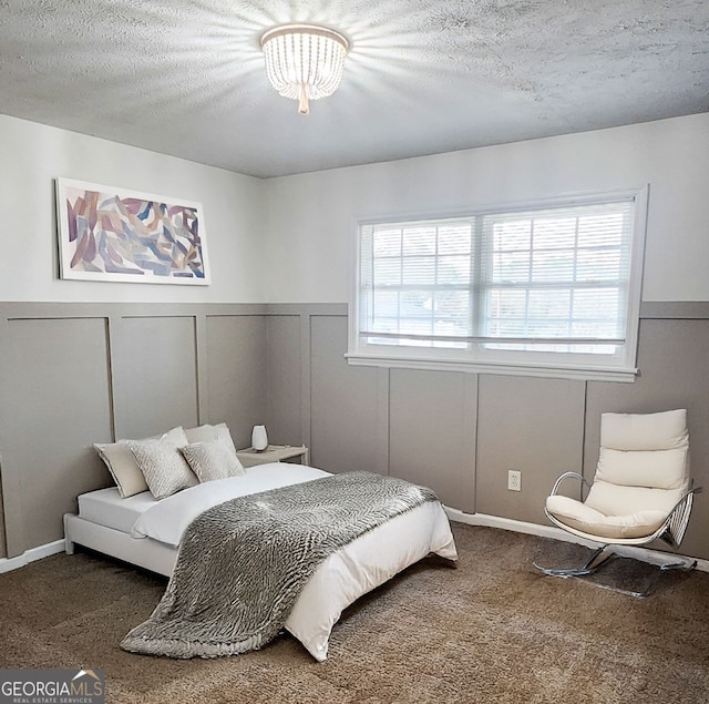 carpeted bedroom featuring a textured ceiling