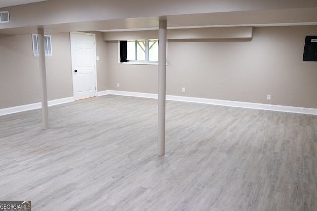 basement with hardwood / wood-style floors