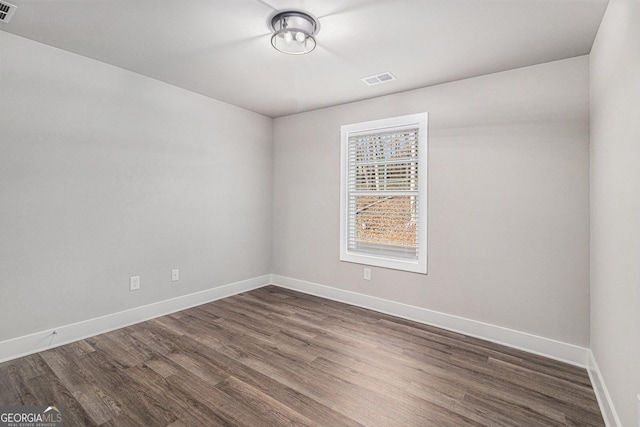 empty room featuring dark hardwood / wood-style flooring