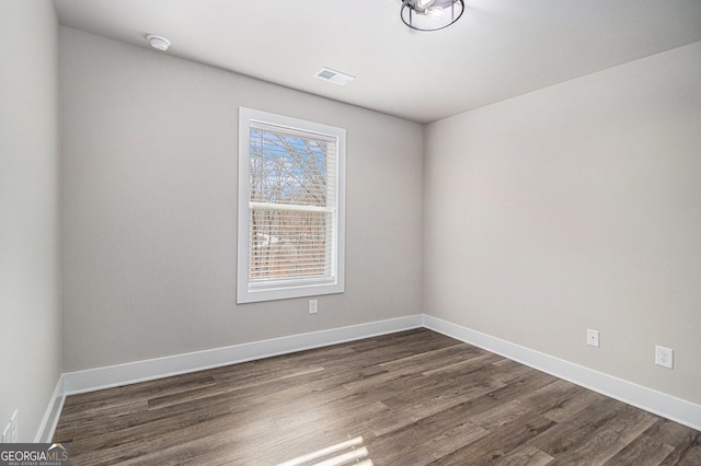 unfurnished room featuring dark hardwood / wood-style floors