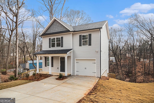 view of property featuring covered porch and a garage