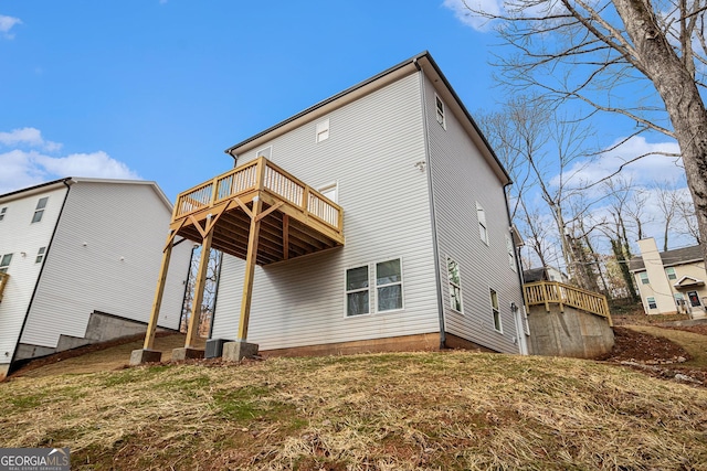 back of house featuring a wooden deck