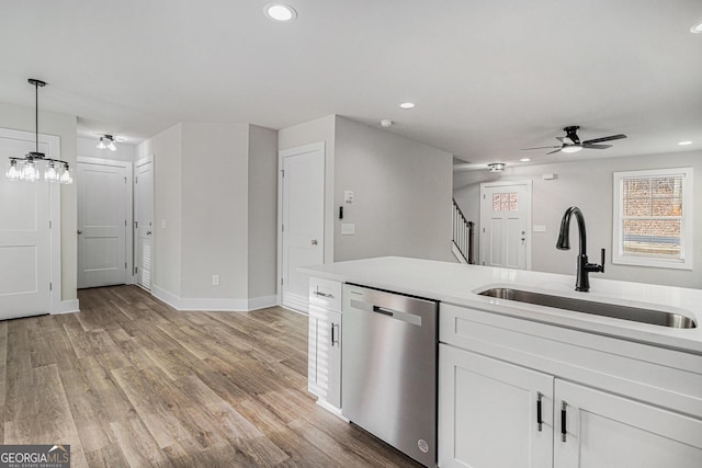 kitchen with white cabinetry, sink, ceiling fan, stainless steel dishwasher, and pendant lighting