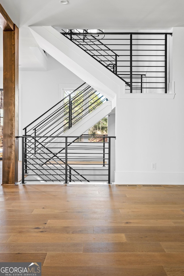 stairway with hardwood / wood-style floors