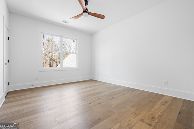 spare room with light hardwood / wood-style floors and ceiling fan