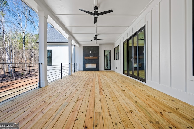 wooden terrace featuring ceiling fan