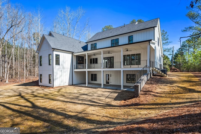 rear view of property featuring ceiling fan, a patio area, and a lawn