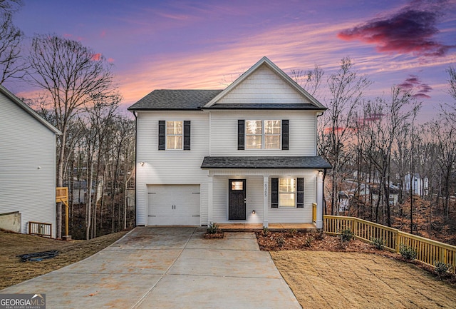 front of property with covered porch and a garage