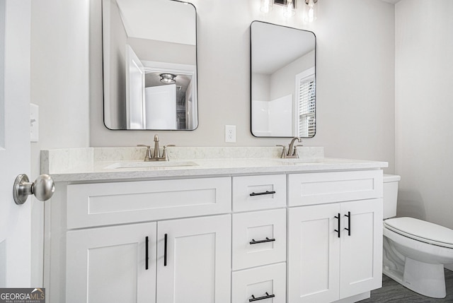 bathroom featuring vanity and toilet