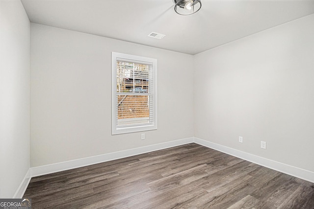 empty room with dark wood-type flooring