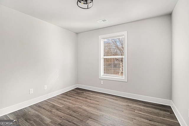 unfurnished room featuring dark wood-type flooring