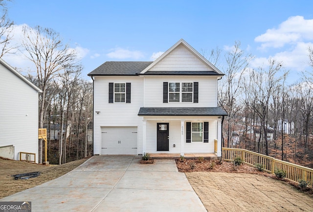 front of property with covered porch and a garage