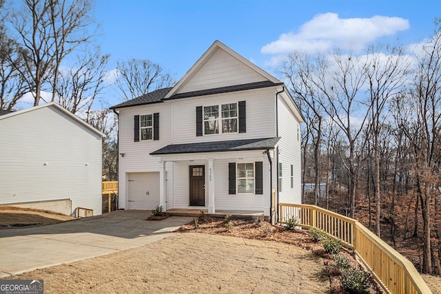 view of front property with covered porch and a garage