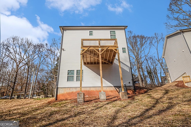 rear view of property with a wooden deck