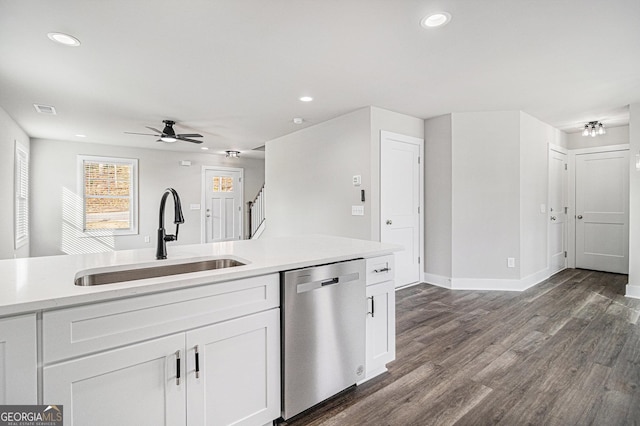 kitchen featuring stainless steel dishwasher, ceiling fan, dark wood-type flooring, sink, and white cabinetry