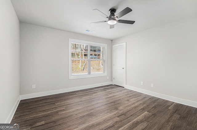 spare room featuring dark hardwood / wood-style floors and ceiling fan