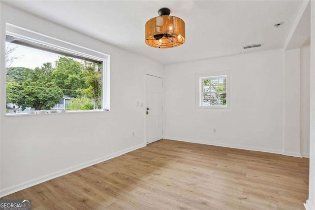 spare room with light hardwood / wood-style flooring