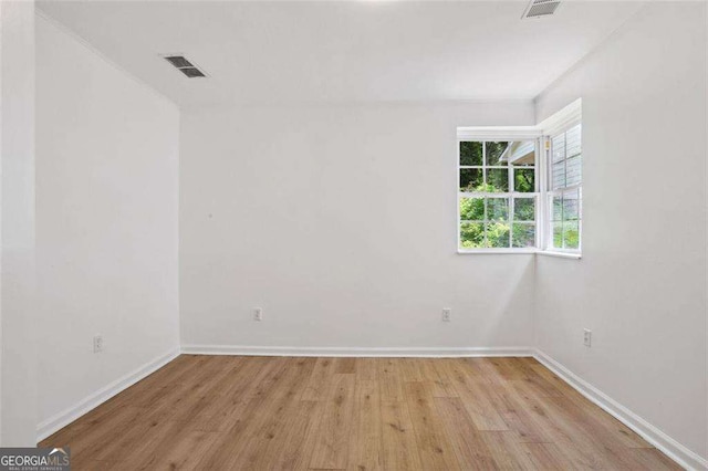 empty room with light hardwood / wood-style flooring