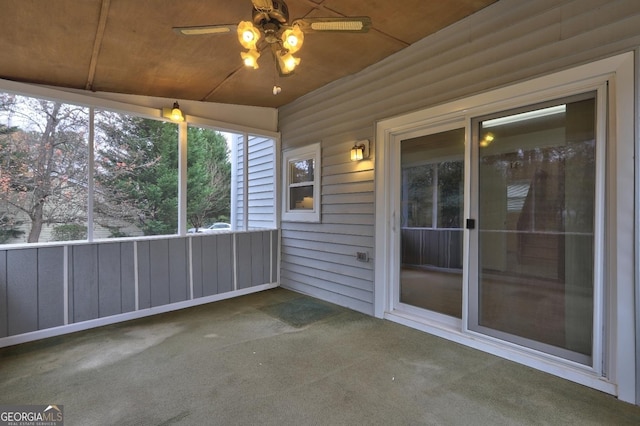 unfurnished sunroom with a ceiling fan