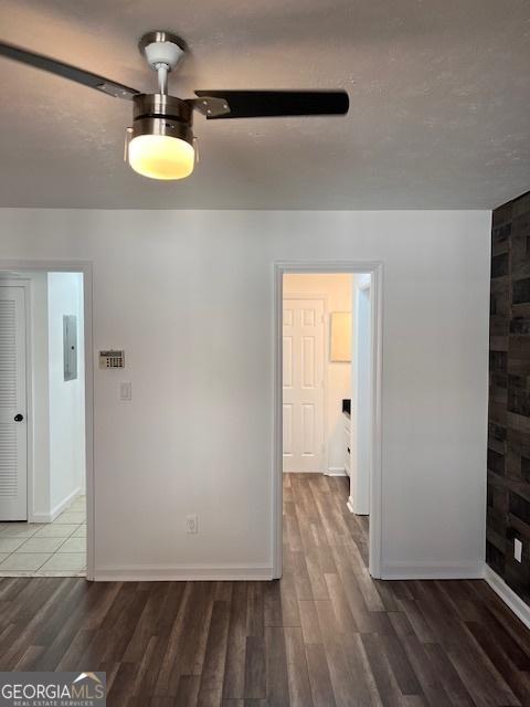 2254 Wellington Cir, Lithonia, GA 30058 - unfurnished room featuring wood finished floors, a ceiling fan, and electric panel