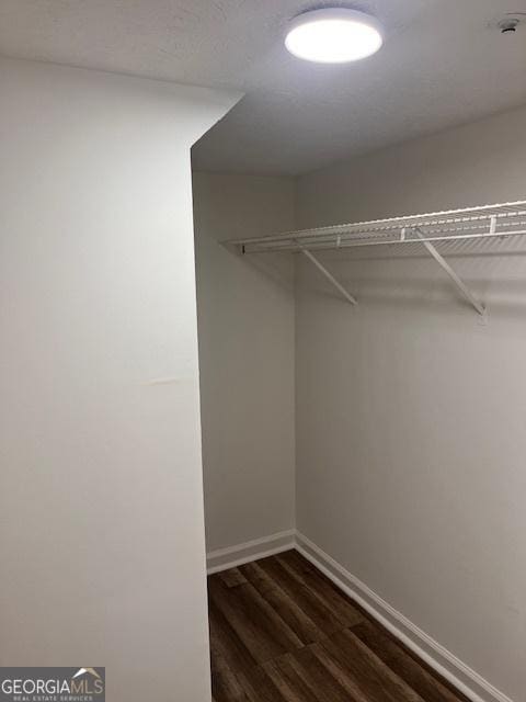 2254 Wellington Cir, Lithonia, GA 30058 - walk in closet featuring dark wood-style flooring