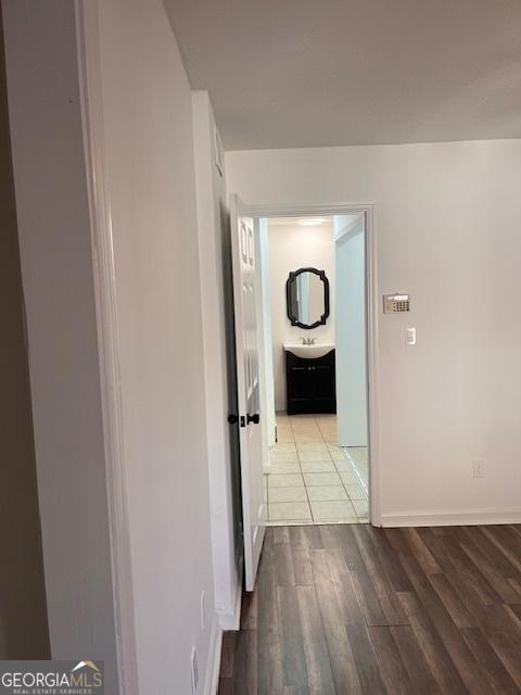 hallway featuring sink and light wood-type flooring