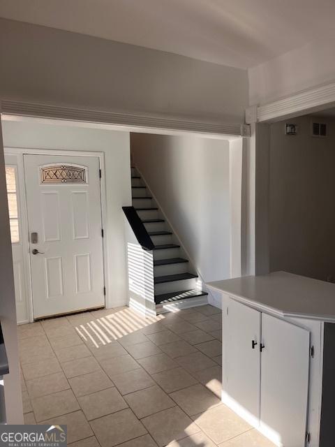 2254 Wellington Cir, Lithonia, GA 30058 - entrance foyer featuring light tile patterned floors and stairs