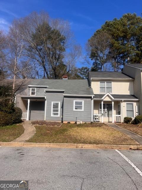2254 Wellington Cir, Lithonia, GA 30058 - view of front of house featuring covered porch and a chimney