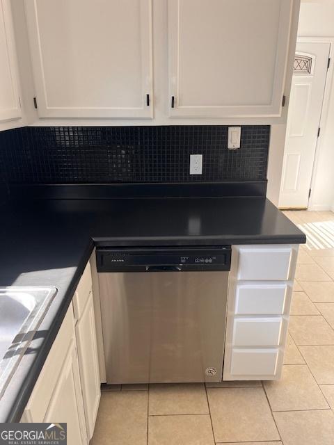 2254 Wellington Cir, Lithonia, GA 30058 - kitchen with dishwasher, light tile patterned floors, white cabinets, and dark countertops