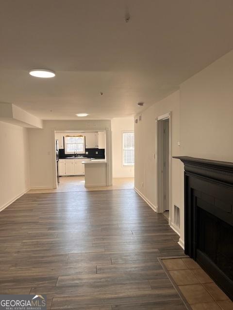 2254 Wellington Cir, Lithonia, GA 30058 - unfurnished living room with a fireplace with flush hearth and dark wood finished floors