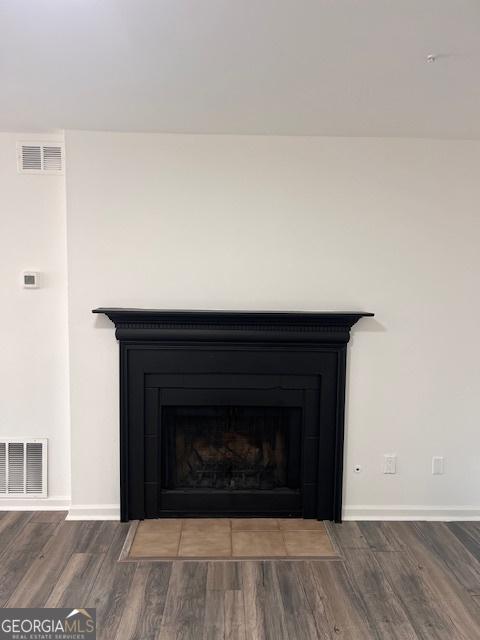 2254 Wellington Cir, Lithonia, GA 30058 - detailed view of wood finished floors and a fireplace with flush hearth