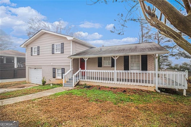 split level home with covered porch and a garage