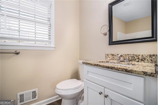 bathroom with vanity and toilet