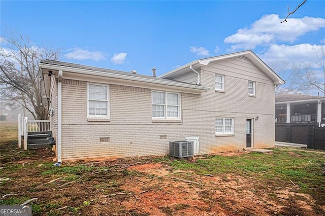 rear view of house featuring central AC unit