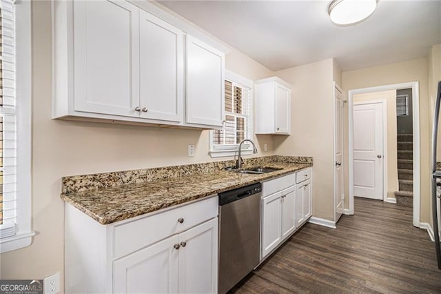 kitchen with stainless steel dishwasher, sink, stone counters, white cabinets, and dark hardwood / wood-style floors