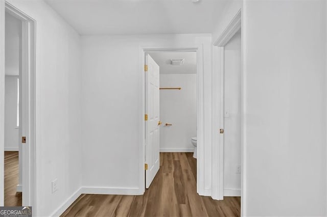 hallway with wood-type flooring