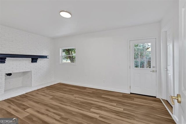 unfurnished living room featuring a healthy amount of sunlight and wood-type flooring