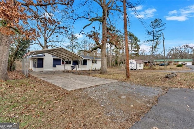 ranch-style house featuring a shed and a carport