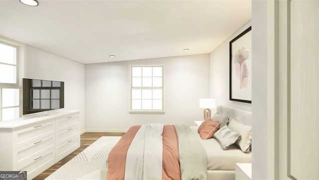 bedroom featuring vaulted ceiling and hardwood / wood-style flooring