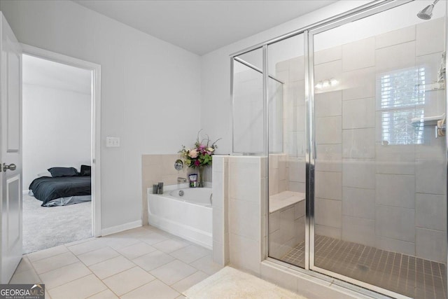 bathroom featuring tile patterned floors and separate shower and tub