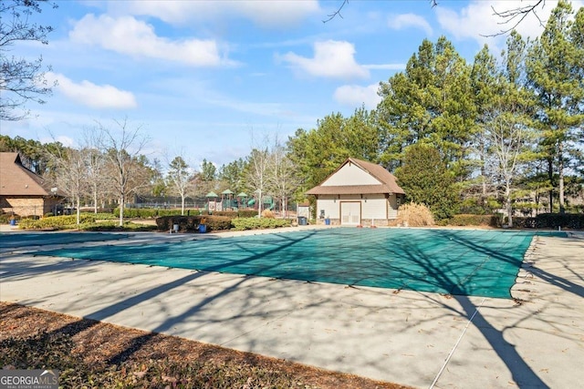 view of pool with a patio area and an outdoor structure