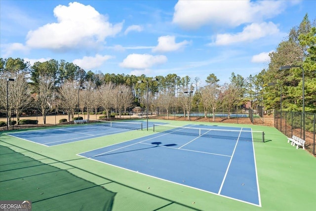 view of tennis court with basketball hoop