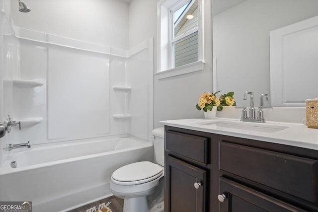 full bathroom featuring bathtub / shower combination, vanity, and toilet