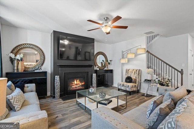 living room with ceiling fan and hardwood / wood-style floors