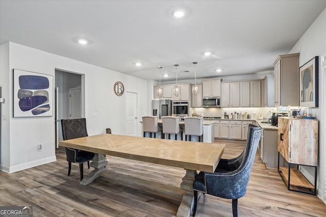 dining space with hardwood / wood-style flooring