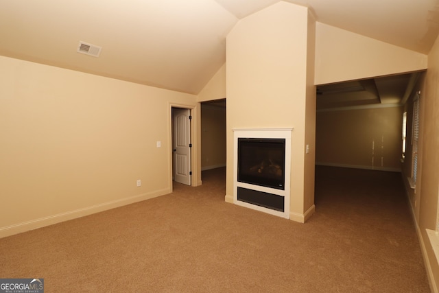 interior space with carpet flooring and vaulted ceiling