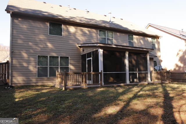 back of house with a sunroom and a yard