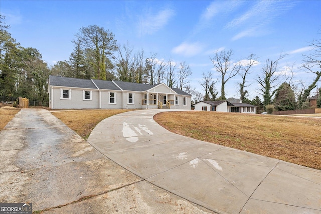 ranch-style home with a front lawn