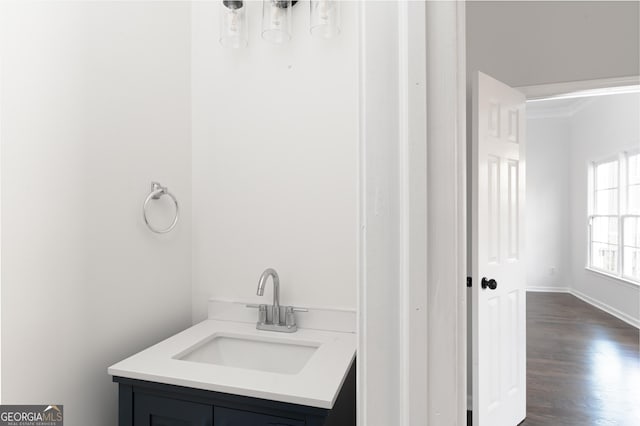 bathroom with hardwood / wood-style floors and vanity